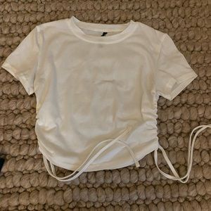Plain white tee, adjustable length from the sides, size small, dress up or down